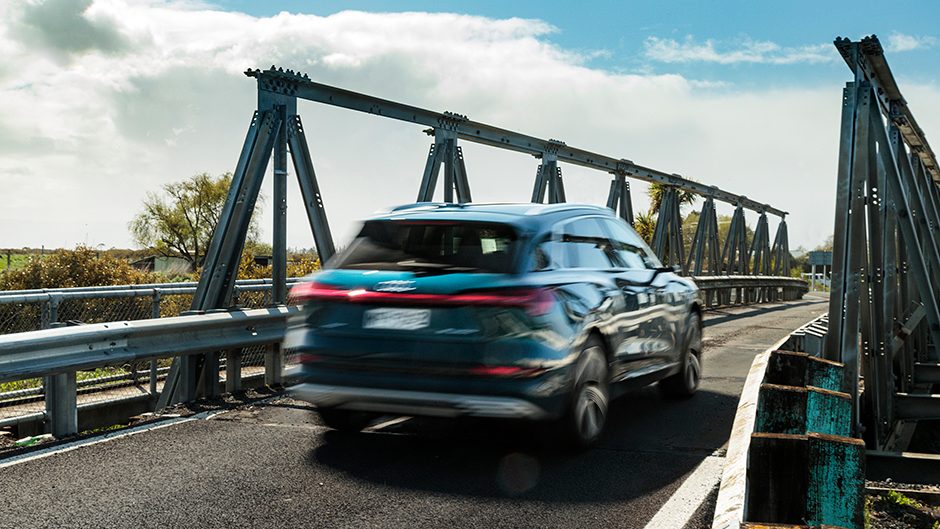 Audi e-tron 55 quattro driving over bridge