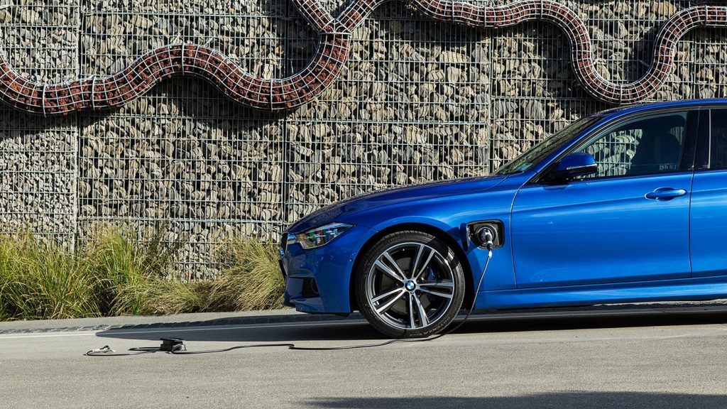 2016 BMW 330e parked in front of sculpture