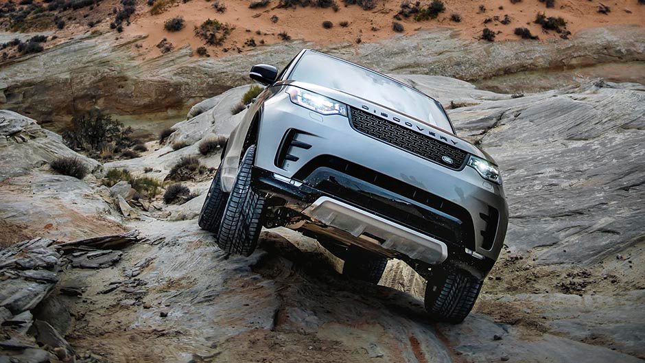 2017 Land Rover Discovery climbing up rocks