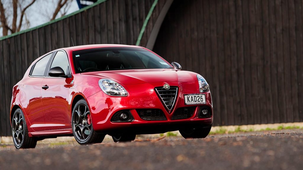 Alfa Romeo Giulietta QV parked by fence