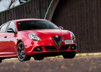 Alfa Romeo Giulietta QV parked by fence