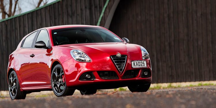 Alfa Romeo Giulietta QV parked by fence