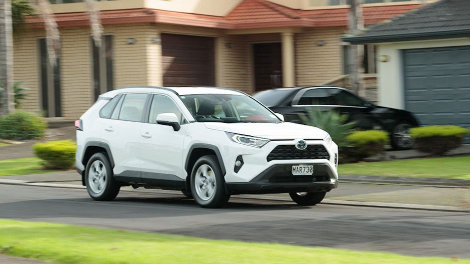 Toyota RAV4 Hybrid driving through suburbia