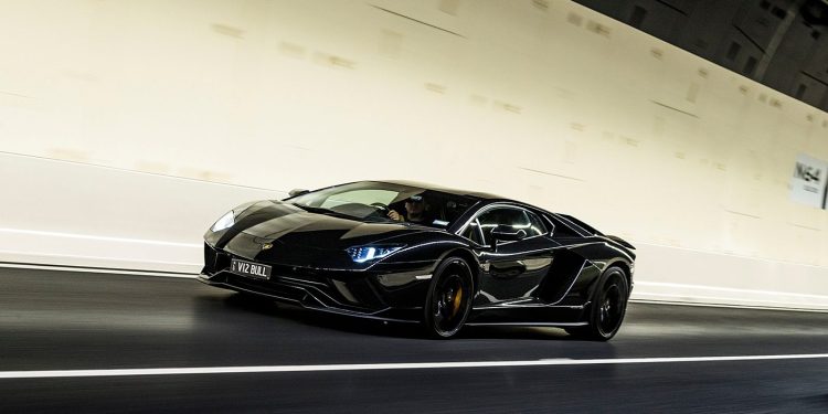 Lamborghini Aventador S front three quarter view driving through tunnel