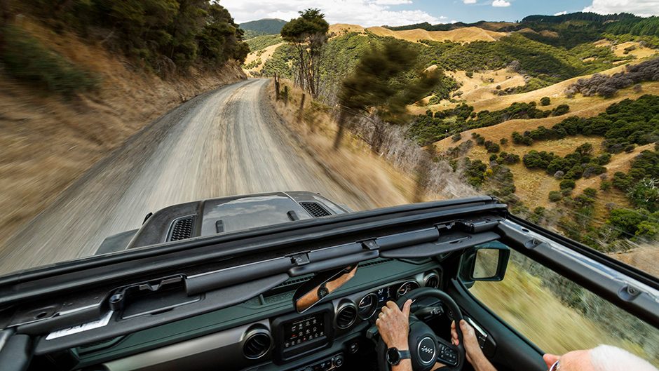 2021 Jeep Gladiator Sport driving down road with no roof