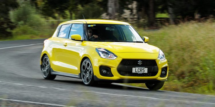 Suzuki Swift Sport front three quarter view driving around corner