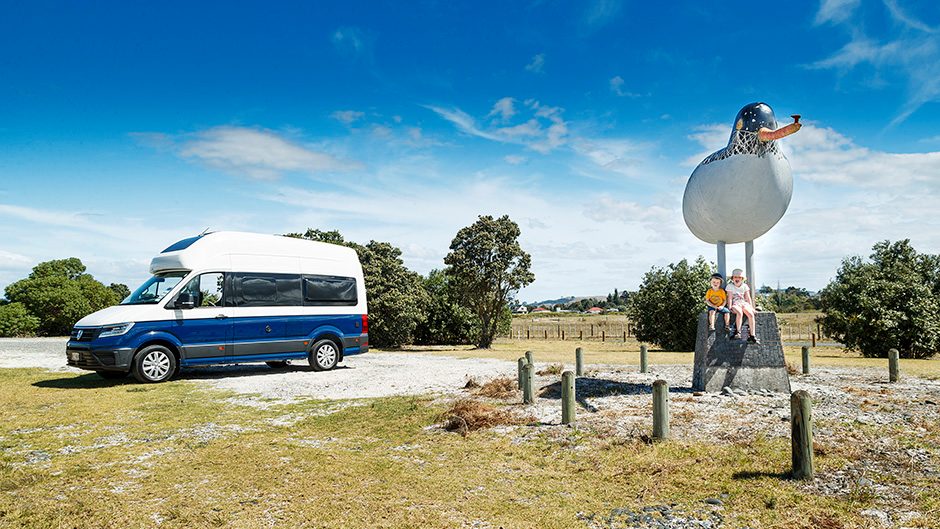 2020 Volkswagen Grand California 600 parked next to giant bird statue