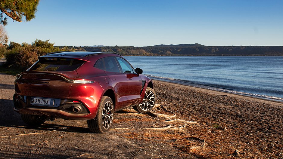 2021 Aston Martin DBX parked on shore of lake Taupo