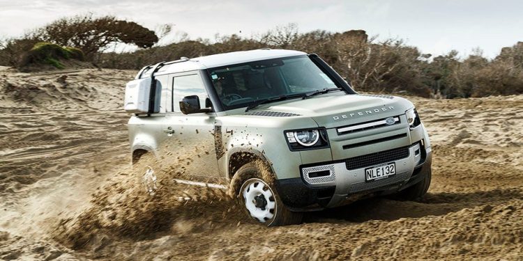 Land Rover Defender drifting in the sand