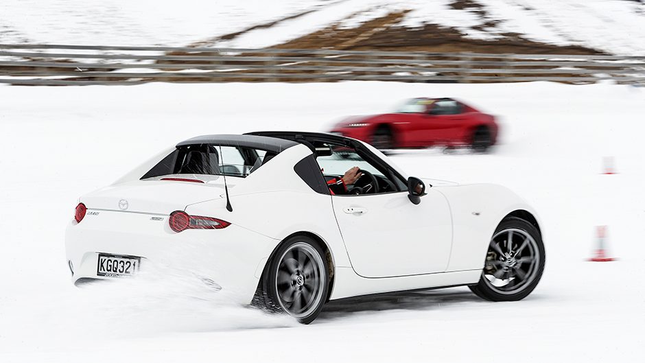 white Mazda MX-5 driving on snow