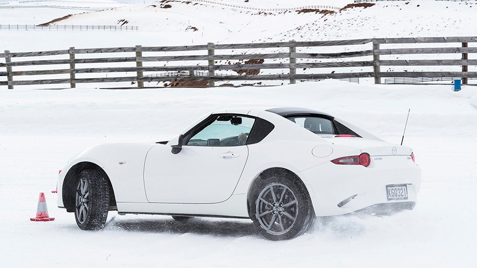 white Mazda MX-5 drifting on snow