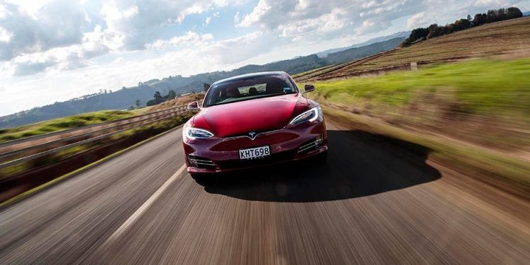 Tesla Model S driving on country road