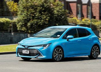 Toyota Corolla Hybrid ZR driving through residential area