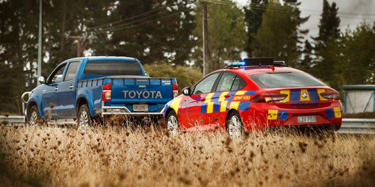 Police car pulling over ute