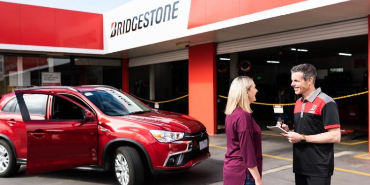 Bridgestone technician handing car keys to customer