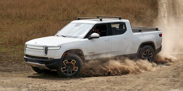 Rivian R1S side view driving on dirt