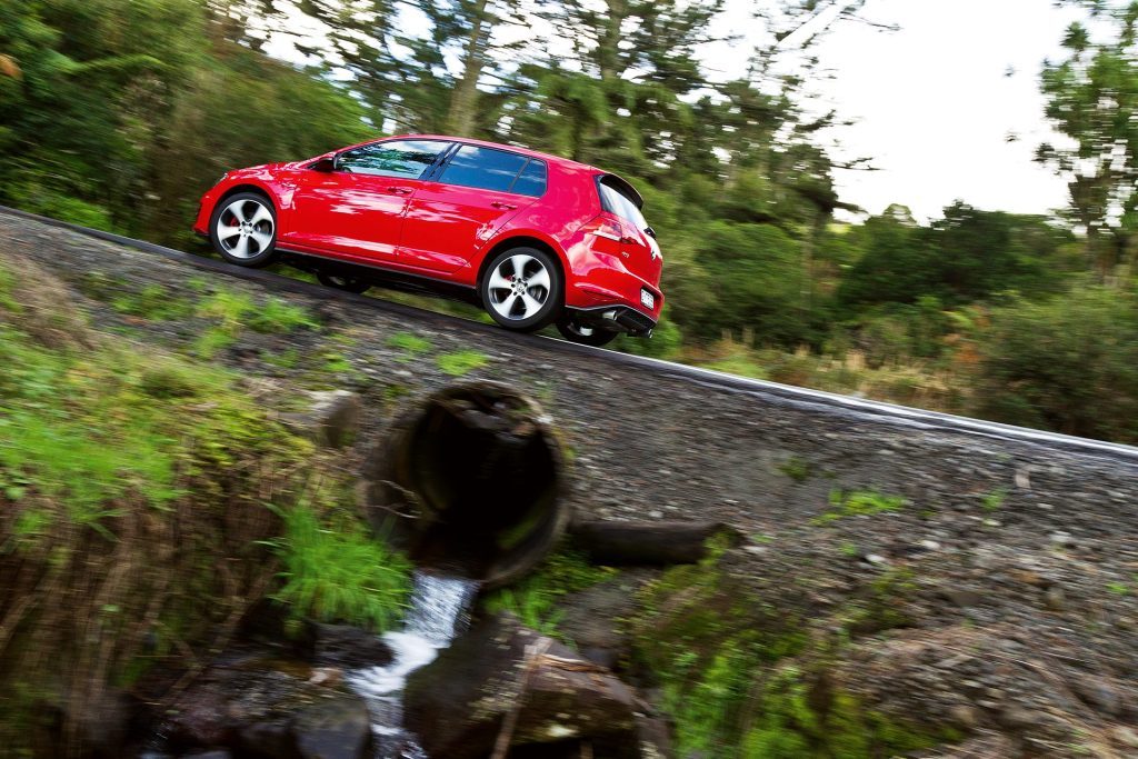 2013 VW Golf GTI driving past water