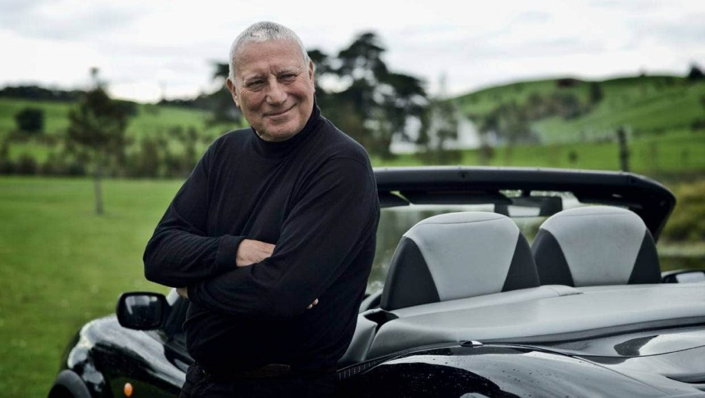 Alan Gibbs standing next to car