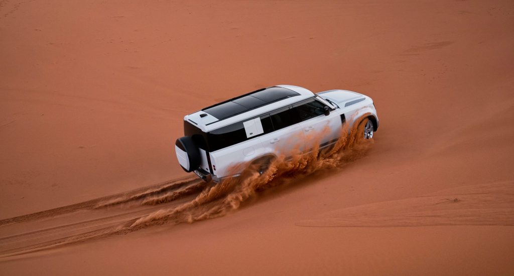 SUV driving through sand