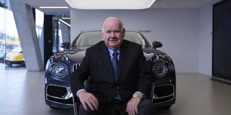 Sir Colin Giltrap sitting in front of Bentley
