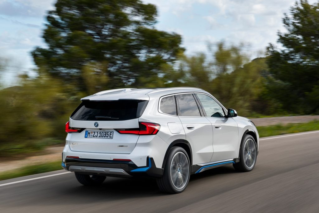 BMW X1 driving at speed on road