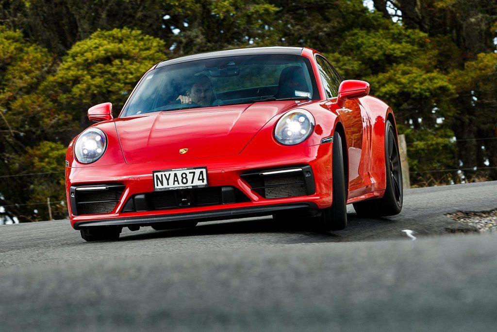 red Porsche 911 GTS low cornering action