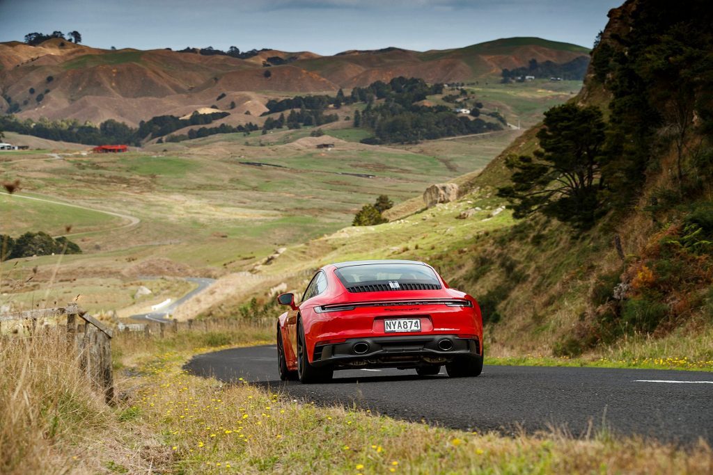 red Porsche 911 GTS scenic rear action