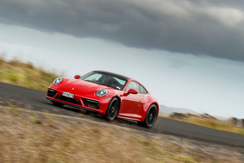 red Porsche 911 GTS inside front cornering action