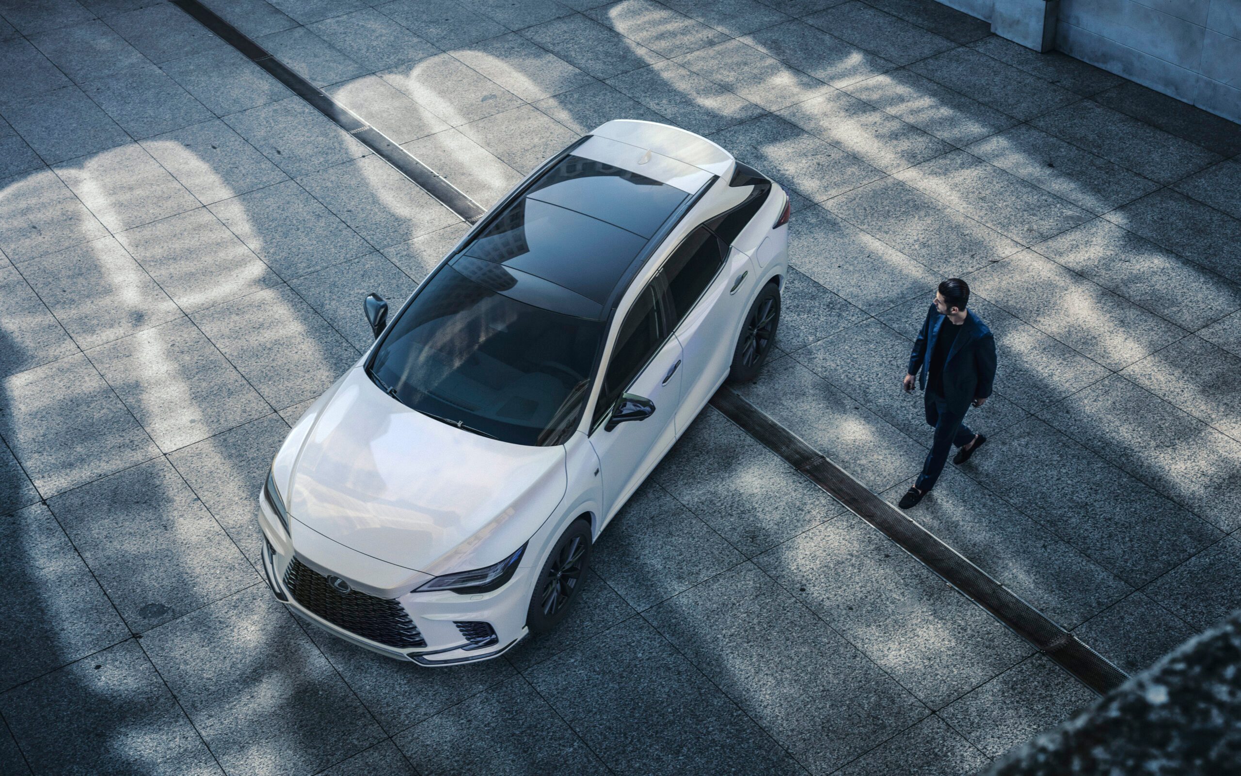 Top down view of man and Lexus RX 
SUV