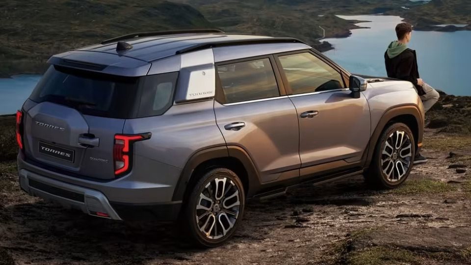 SsangYong Torres rear three quarter shot with man on hill