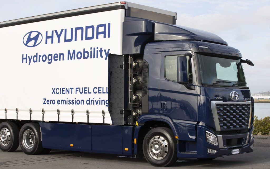 Hyundai Xcient hydrogen-powered fuel cell electric truck front three quarters close with fuel cell doors open