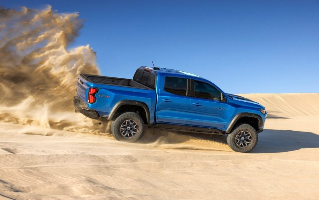 2023 Chevrolet Colorado ZR2 Desert Boss driving through sand dunes side