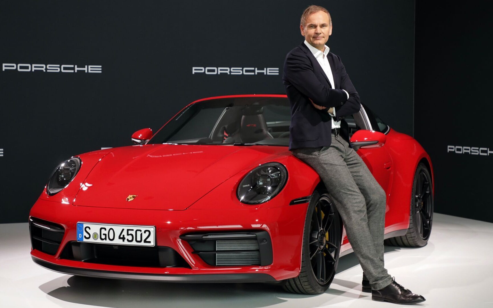 Porsche Chairman Oliver Blume standing next to Porsche 911 Targa