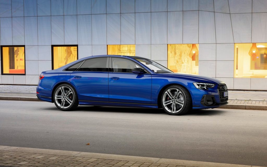 Audi S8 performance sedan side next to buildings