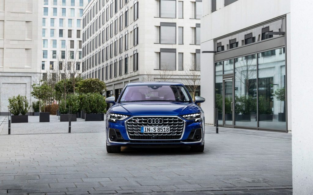 Audi S8 performance sedan front next to buildings