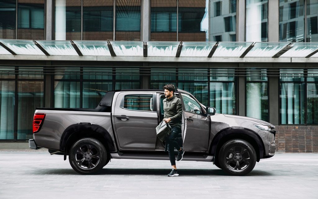 Mazda BT-50 side in city with person stepping out