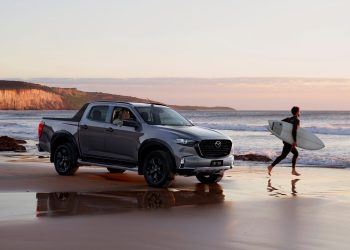 Mazda BT-50 front three quarters on beach with surfer
