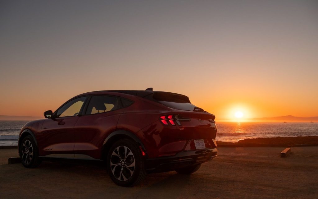 Ford Mustang Mach-E rear three quarters sunset