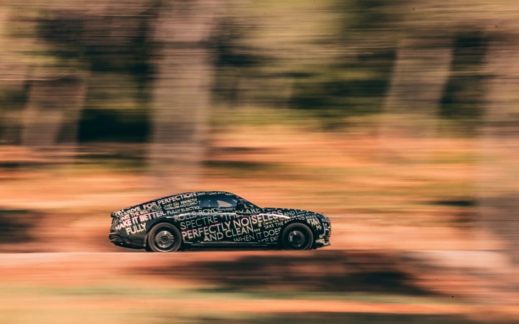 Rolls-Royce Spectre EV camouflaged driving fast side