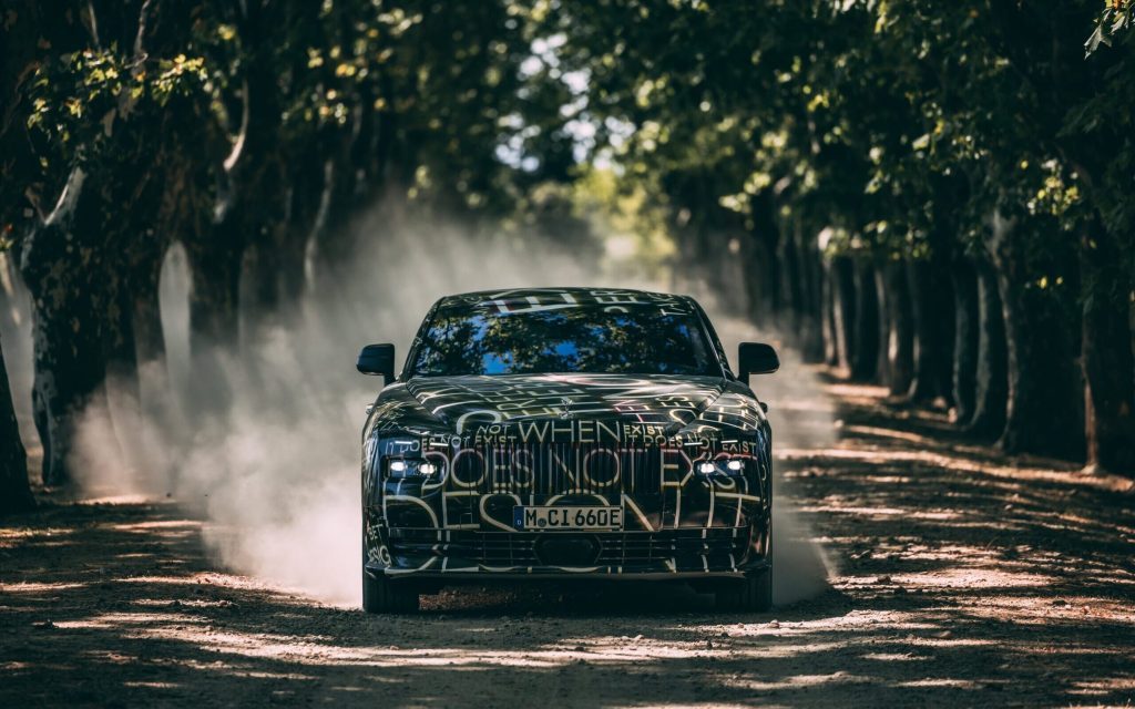 Rolls-Royce Spectre EV camouflaged driving through trees front