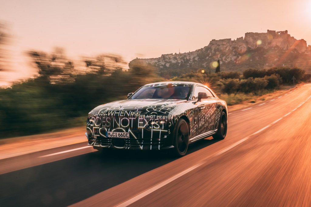 Rolls-Royce Spectre EV camouflaged driving front three quarters