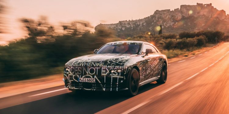 Rolls-Royce Spectre EV camouflaged driving front three quarters