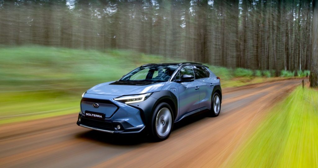 Subaru Solterra EV SUV driving through forest