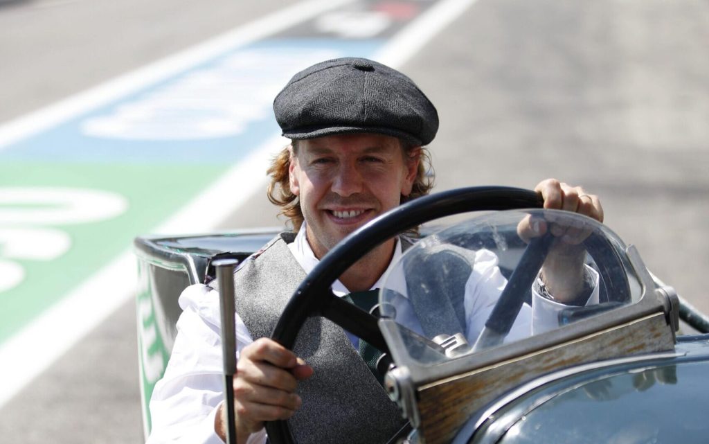 Sebastian Vettel sitting in 1922 Aston Martin TT1 Green Pea