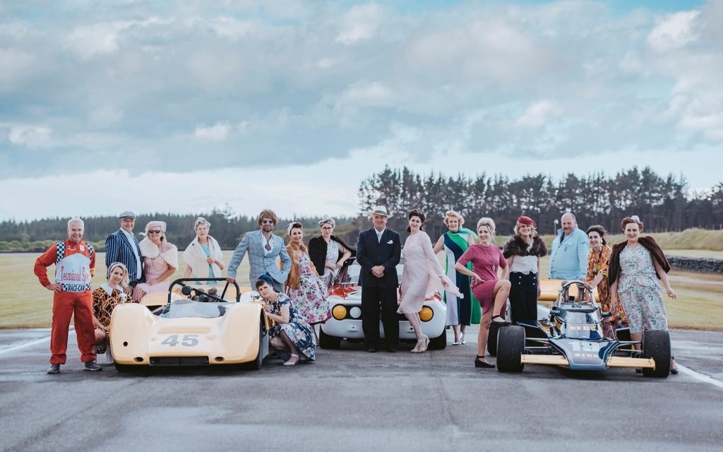 People standing around racecars at Teretonga Park Raceway at George Begg Festival