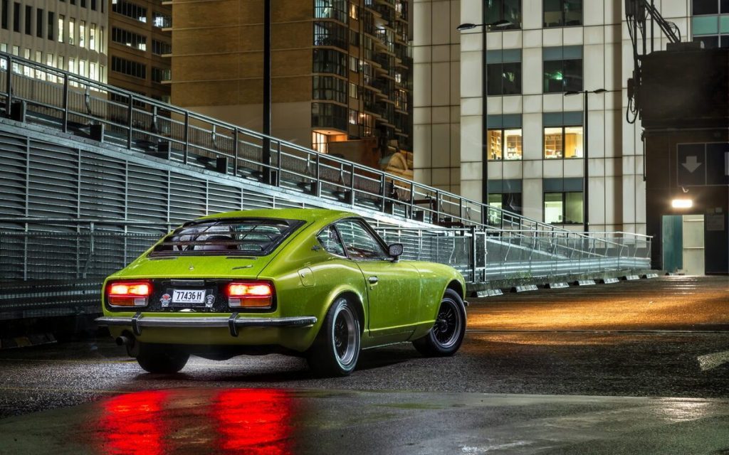 Nissan 240Z rear three quarter view on parking garage at night