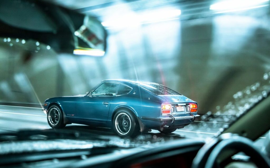 Nissan 260Z rear three quarter view driving through tunnel