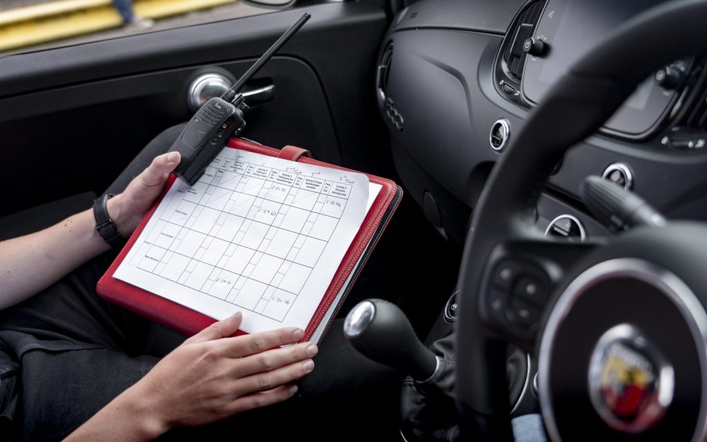 Abarth interior with person holding sheet