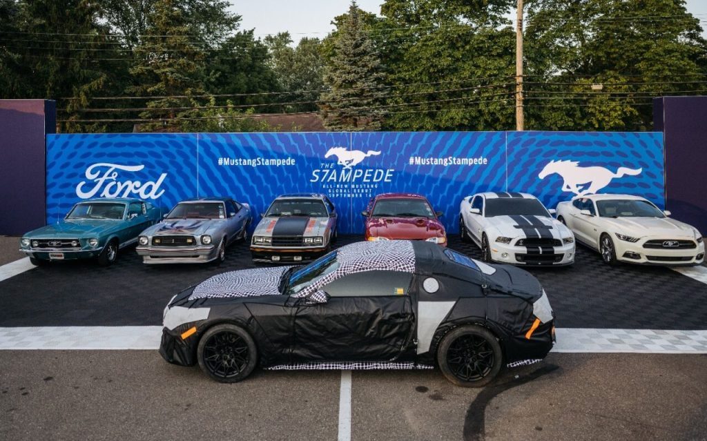 Seventh-generation Ford Mustang in front of old models