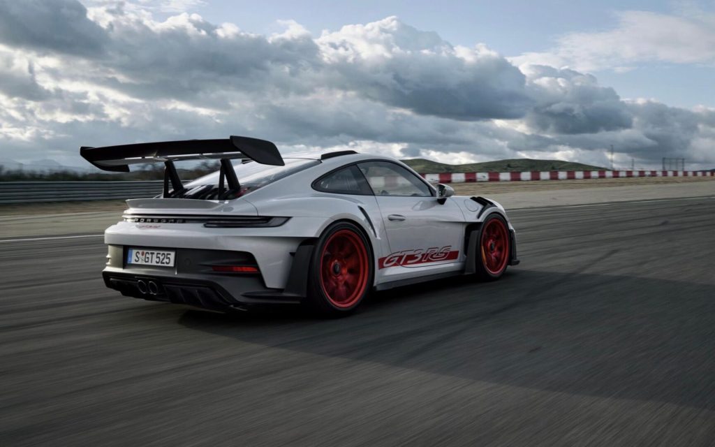 Porsche 911 GT3 RS 992-generation rear three quarter view driving on track